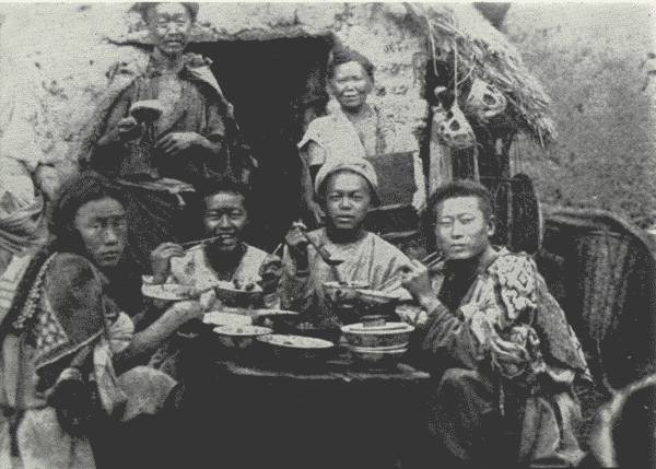 A REAL ABORIGINAL FEAST  The man on the left scowled in anger as the Author snapped his picture—otherwise, all were happy. For them an exceptional feast, not an everyday affair.