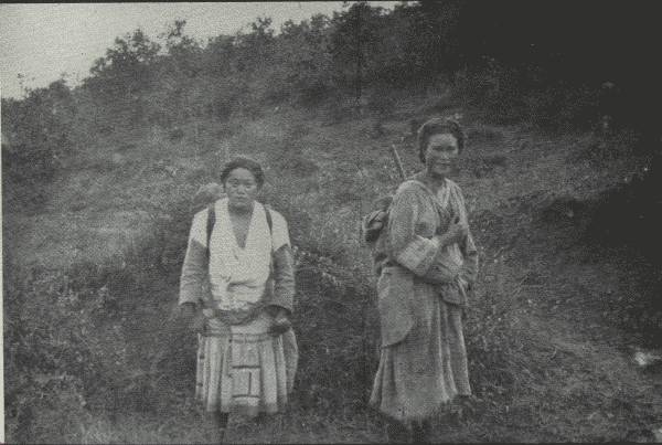 TWO VERY PRACTICAL WOMEN  Though their tribes have lived on same range of mountains "for eighty centuries," they speak different languages and lead different life generally. (One carries baby.)