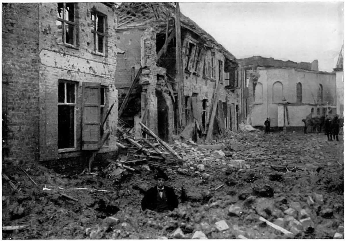 A WAIST-DEEP SHELL-HOLE IN A BELGIAN STREET: IN A WAR-WRECKED WEST FLANDERS TOWNSHIP