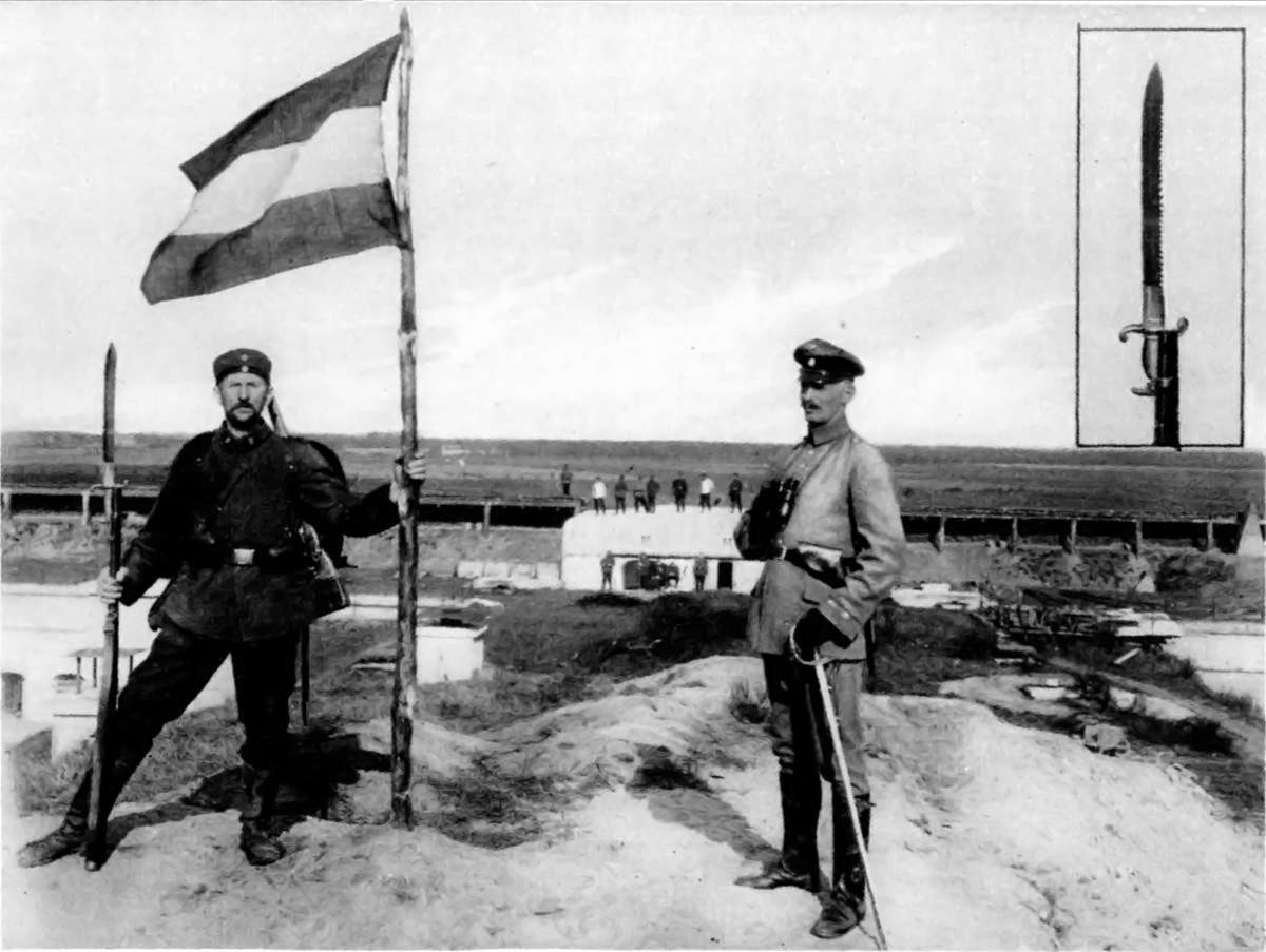 A GERMAN SAW-EDGE BAYONET IN ACTUAL USE IN THE WAR: WHEN THE GERMAN FLAG WAS PLANTED ON A CAPTURED POSITION.