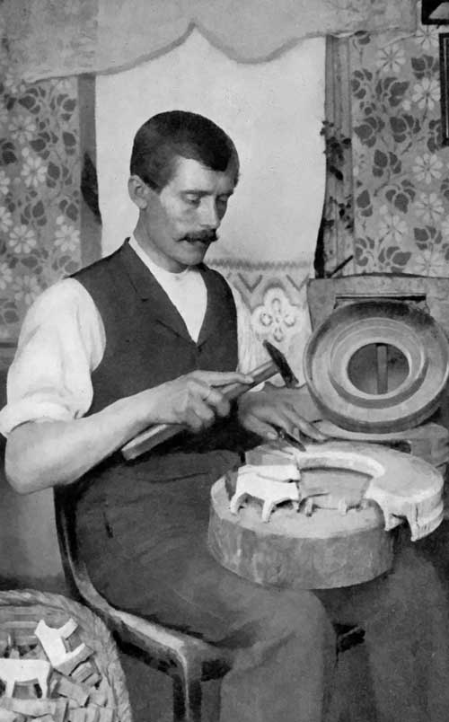 Toy-making in Germany.  How the rough figures are chipped from the wooden ring coming from the cross-section of a tree.