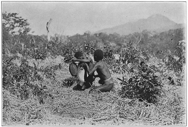 Negrito men of Bataan beating gongs and dancing.