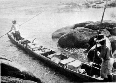 Taking the Canoe and Part of the Baggage down a Narrow Passage among Rocks.