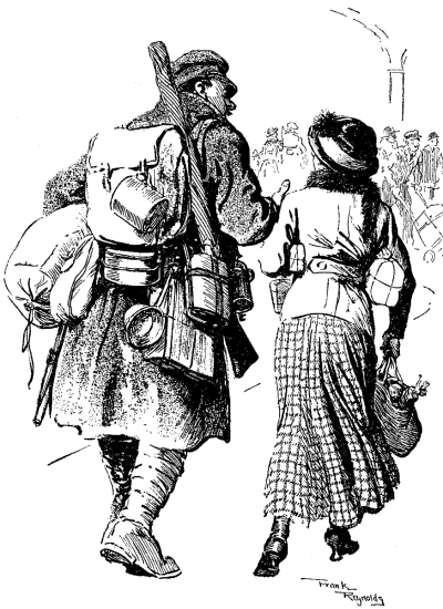 Heavily laden British soldier walking with a small woman with packages.