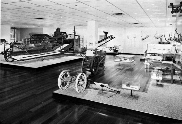 Figure 20.--A view in the Hall of Farm Machinery, National Museum of History and Technology. The Holt combine in 1887 (Catalog No. 241) is at left. The Victor mowing machine of 1880 (Catalog No. 137) is in right foreground.