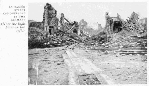 LA BASSÉE. STREET CAMOUFLAGED BY THE GERMANS (Note the high poles on the left.)