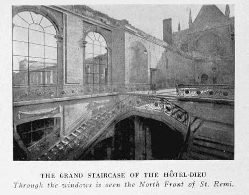 THE GRAND STAIRCASE OF THE HÔTEL-DIEU Through the windows is seen the North Front of St. Remi.