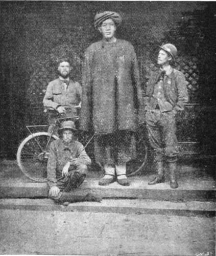 THE THREE WORLD CYCLISTS AND A CHINESE GIANT WHO DOES NOT CYCLE.