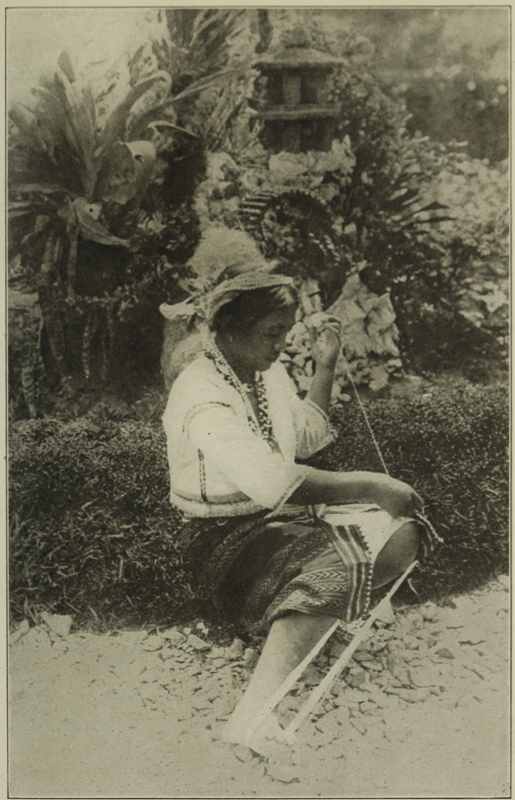 IGOROT SCHOOL GIRL WEAVING.