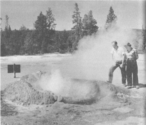 Visitors examine the weird crater of Comet Geyser