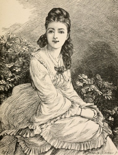 seated woman wearing white looking directly at viewer