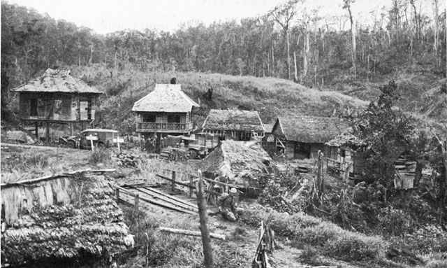 AMERICAN TROOPS IN LIMON (above), and taking cover there as enemy shells hit the area (below).