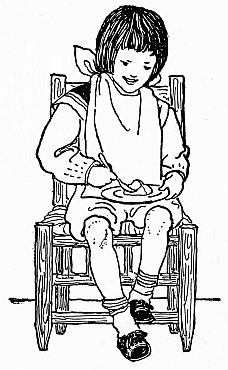 boy with large napkin around neck and plate on lap