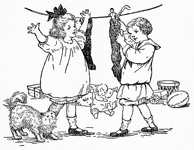 children with stockings hung on line, cat at feet