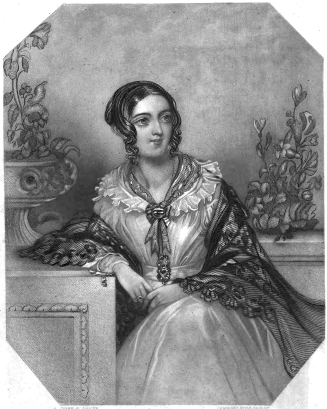 a seated young woman leaning on a cabinet