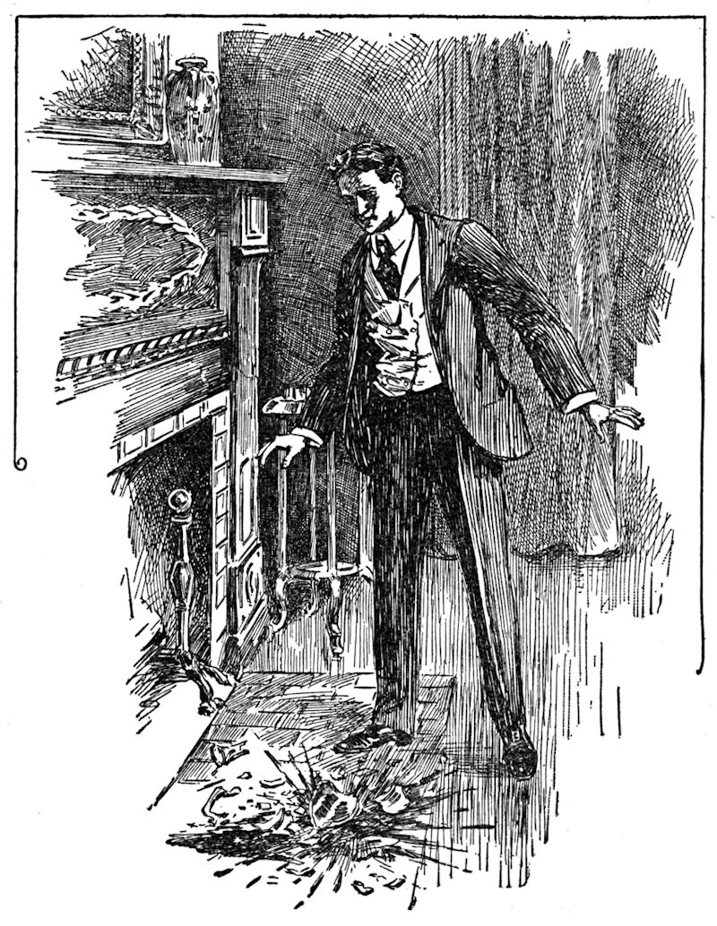A man looking down at a broken decanter
