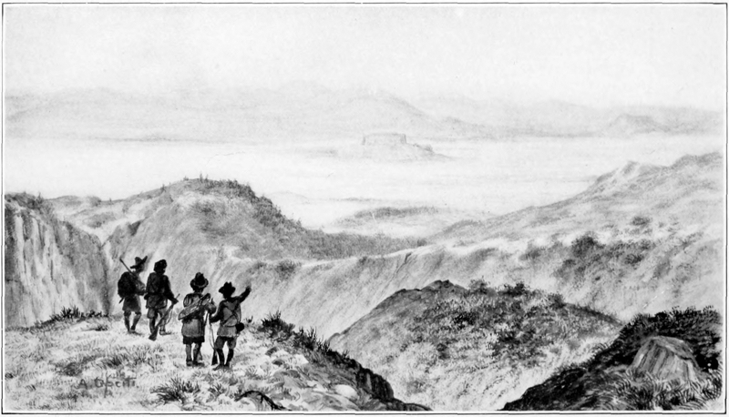 four men, standing on a hill, look down on distant a valley and hills