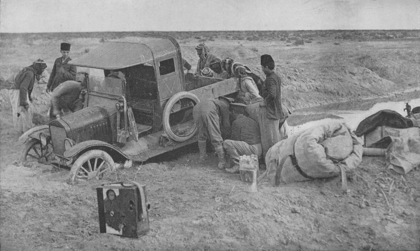 Photo wide shot of armoured car with front wheels buried up to the axles