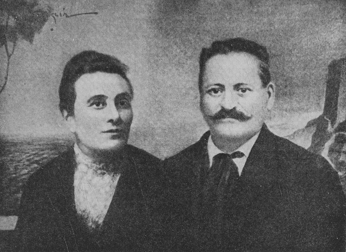 Woman and man in front of photo backdrop