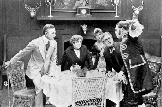 A footman interrupts in the dining room.