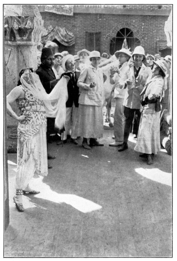 The travellers gawk at a scantily veiled woman in a Middle-eastern marketplace.