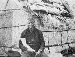 b. Outside an elm-bark structure. At the Ojibway village of Sagawamick, on south shore of
Mille Lac, Minnesota. May 21, 1900